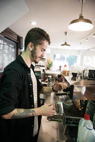 Barista making coffee inside a cafe
