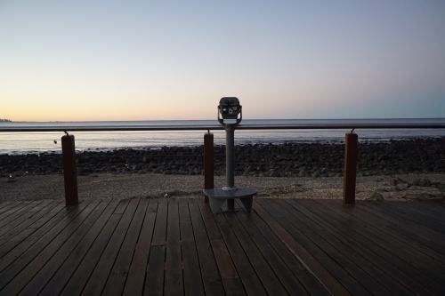 Binoculars look out over beach sunset