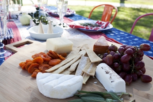 Cheese board on outdoor table ready for Christmas celebration