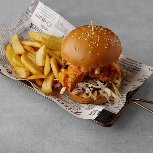 Chicken burger and chips on table