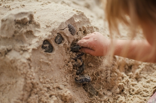 Child making sandcastles