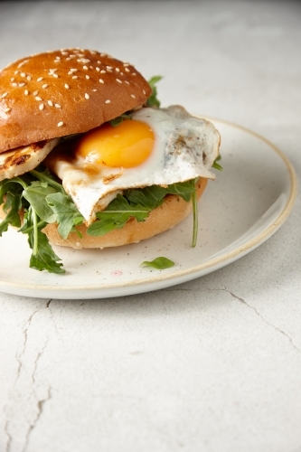 Close up of haloumi and egg burger on plate
