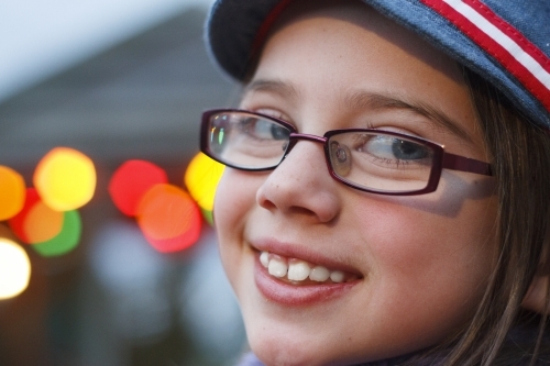 Close up of smiling girl with bokeh lights in the background