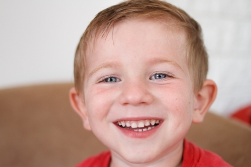 Close up of young boy with a big smile