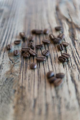 Coffee beans with wood grain table background