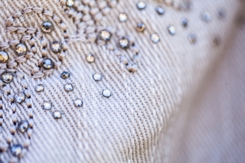 Diamante sparkles and threads making pattern on clothing