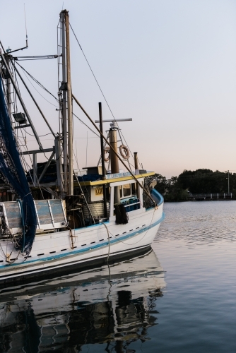 Fishing Trawler on a river at dusk