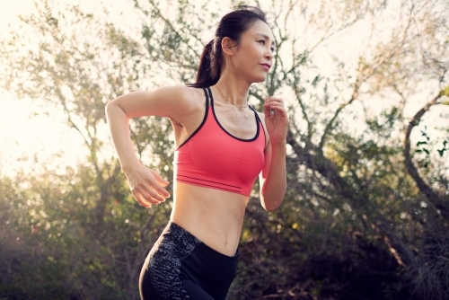 Fit Asian woman running for morning exercise