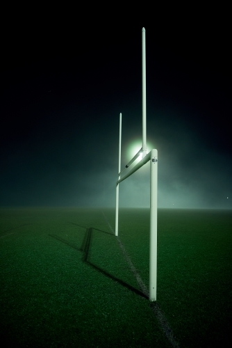 Goal posts on the sports oval in the fog at night