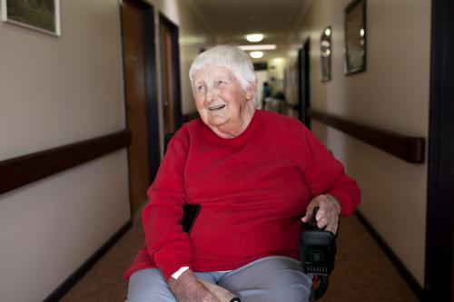 Happy nursing home resident sitting in wheelchair