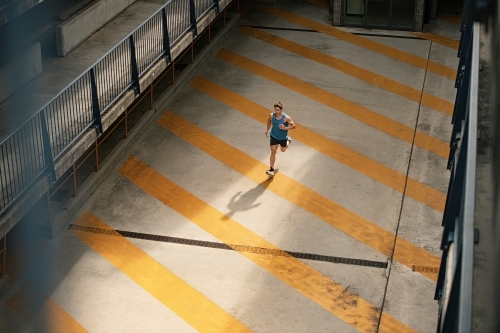 Male runner running through urban setting