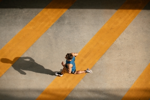 Male runner running through urban setting