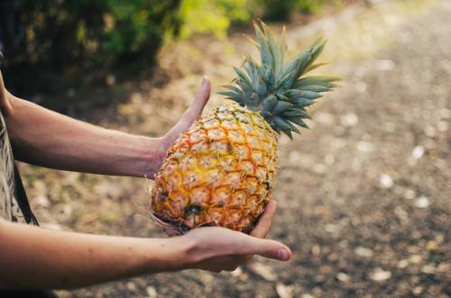 Man holding a pineapple in hands