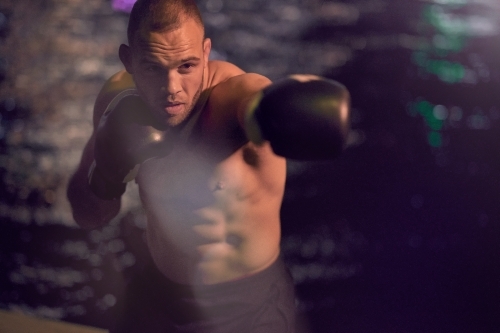 Man in urban city boxing fitness training