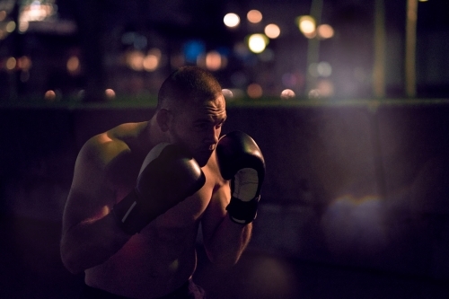 Man in urban city boxing fitness training