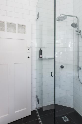 Modern white shower in bathroom renovation with brick pattern subway style tiling