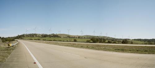 Motorway and hillside of wind turbines