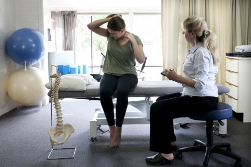 Physiotherapist in consultation with patient