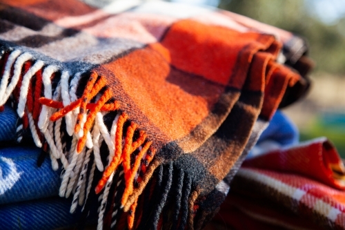 Pile of blankets on grass in winter for outdoor picnic