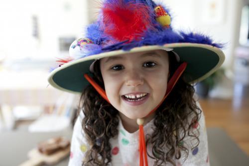 Smiling young girl with hand made Easter hat