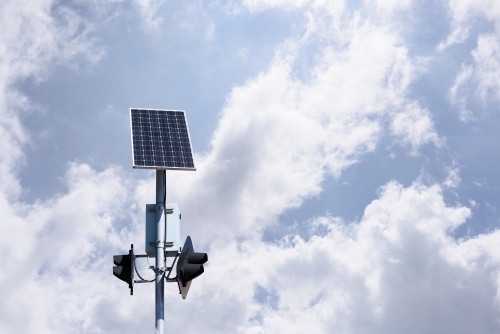 Solar panel powered traffic light against blue sky background, clean energy in use, in Melbourne