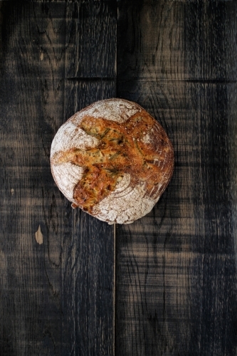 Sourdough loaf of bread on dark background