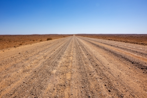 stretch of dirt road in desert landscape