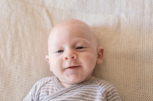 Young baby boy smiling at camera