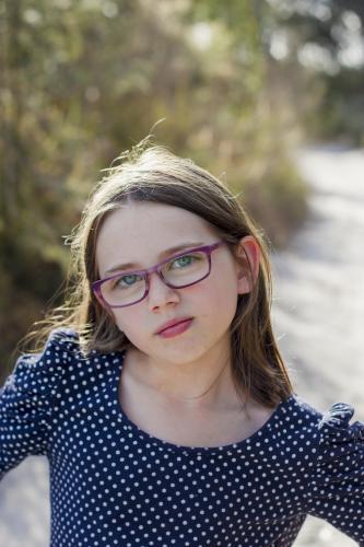 Young girl with glasses in bushland