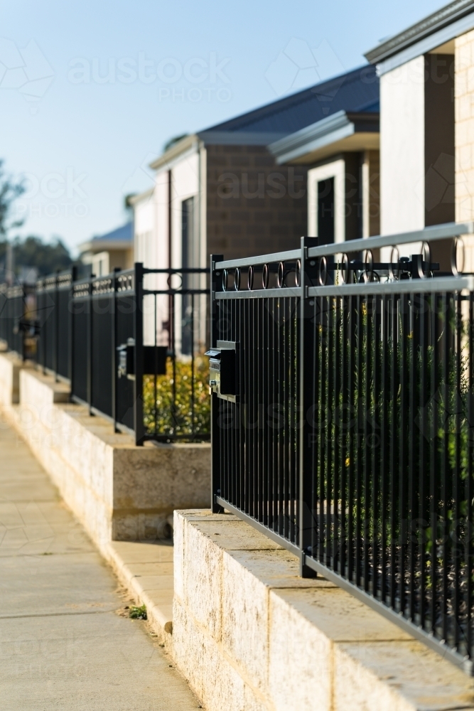 Retaining wall and fence at front of suburban property - Australian Stock Image