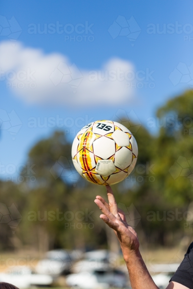 Soccer ball spinning on finger - Australian Stock Image