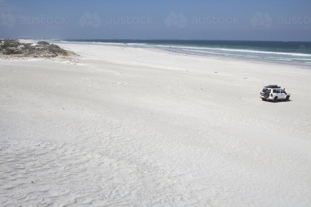 4WD on white sandy beach - Australian Stock Image