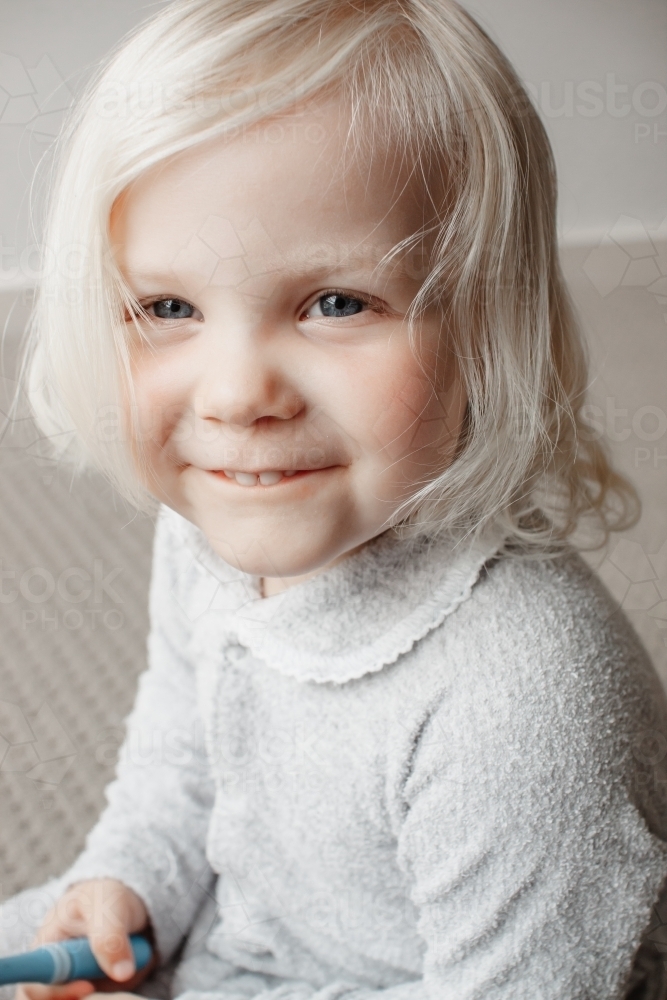 A blonde haired blue eyed two year old caucasian girl portrait - Australian Stock Image