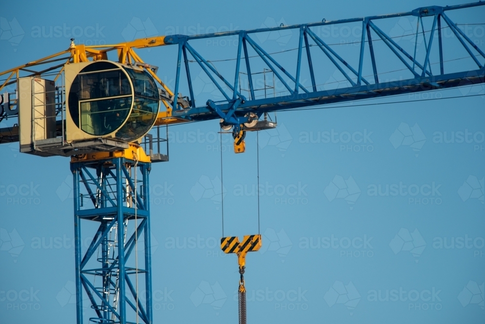 A building crane against a blue sky background - Australian Stock Image