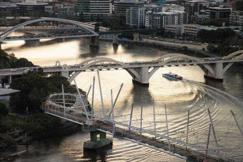 A CityCat ferry boat passes under the William Jolly Bridge on the Brisbane River - Australian Stock Image