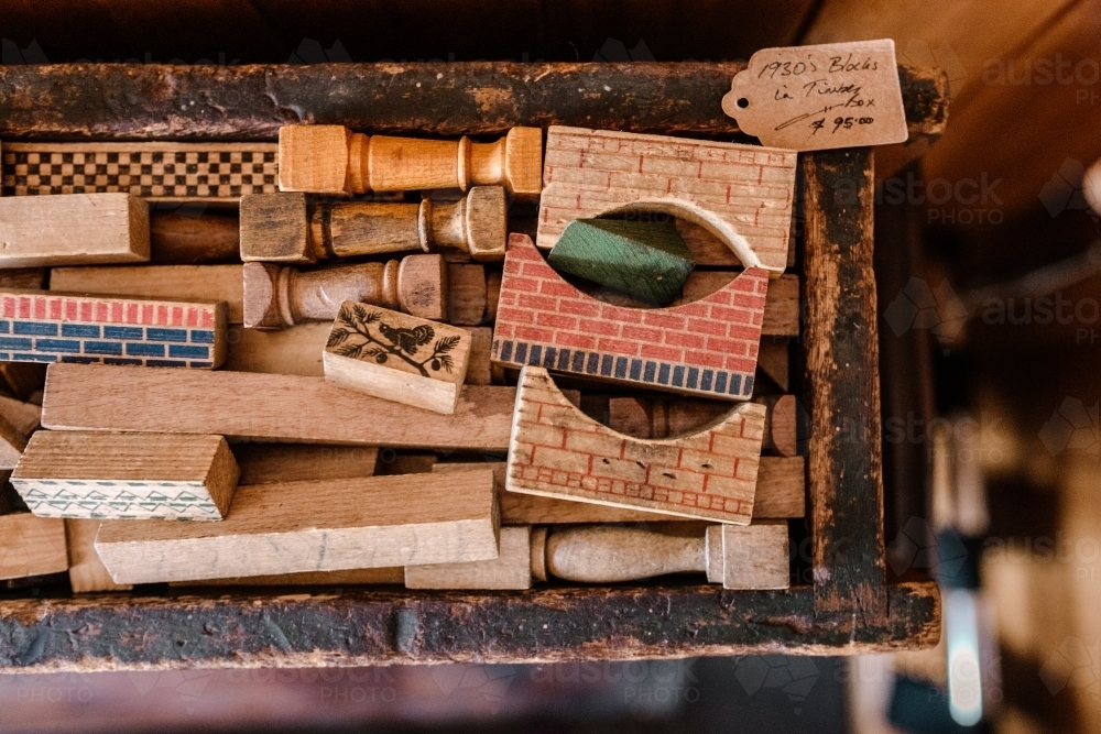 A collection of various wooden rubber stamps with different patterns and designs. - Australian Stock Image