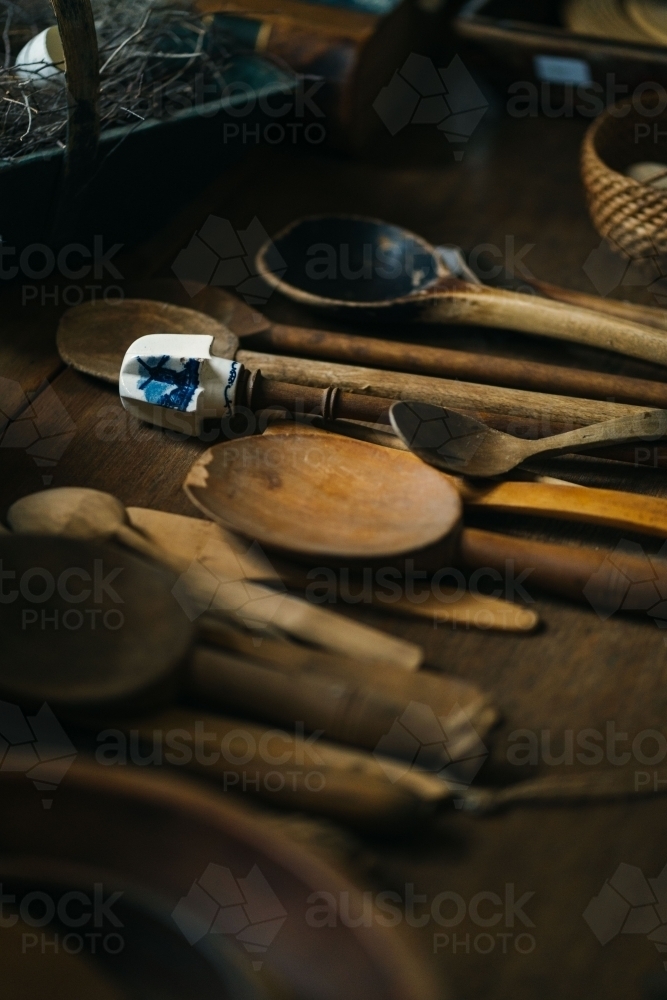 A collection of wooden spoons with different sizes laid on the table - Australian Stock Image