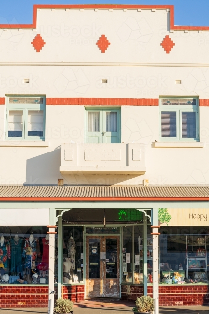 A colourful facade of an historic shopfront with veranda and balcony doors - Australian Stock Image