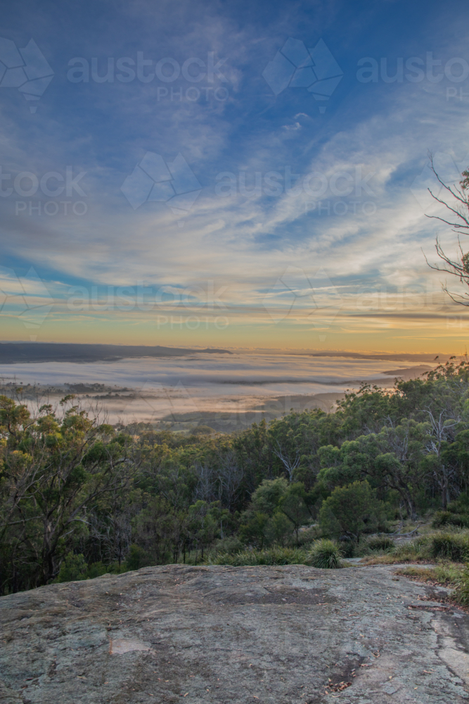 A colourful morning sky over a granite lookout - Australian Stock Image