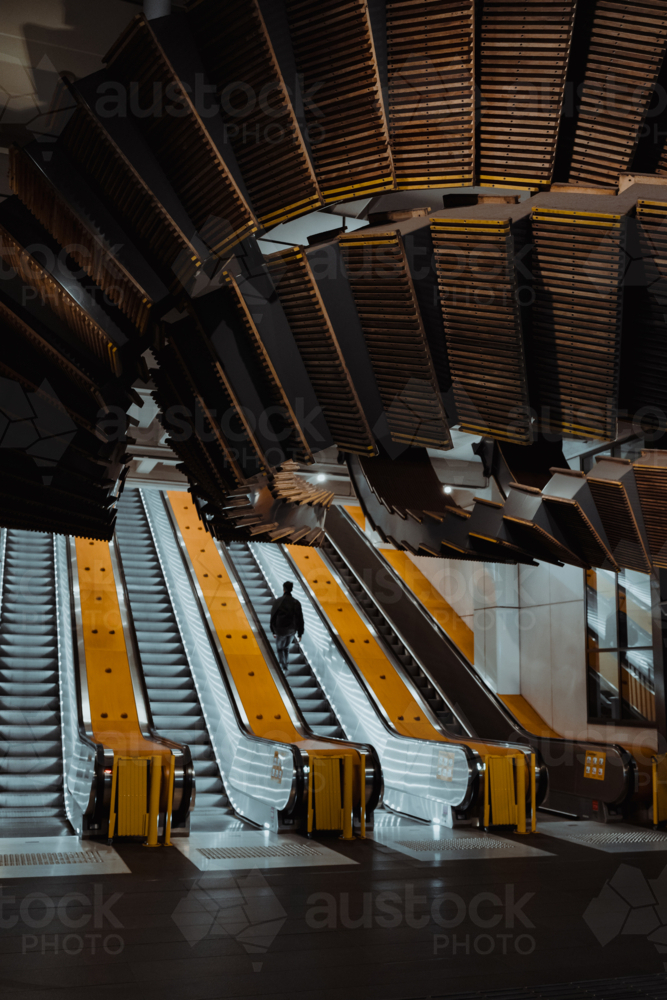 A commuter using the escalators at Wynyard Station - Australian Stock Image