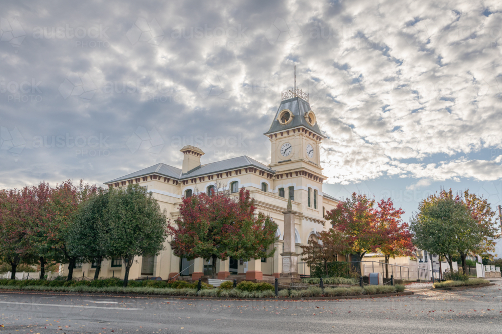 A country town post office building with autumn trees and cloudy skies - Australian Stock Image