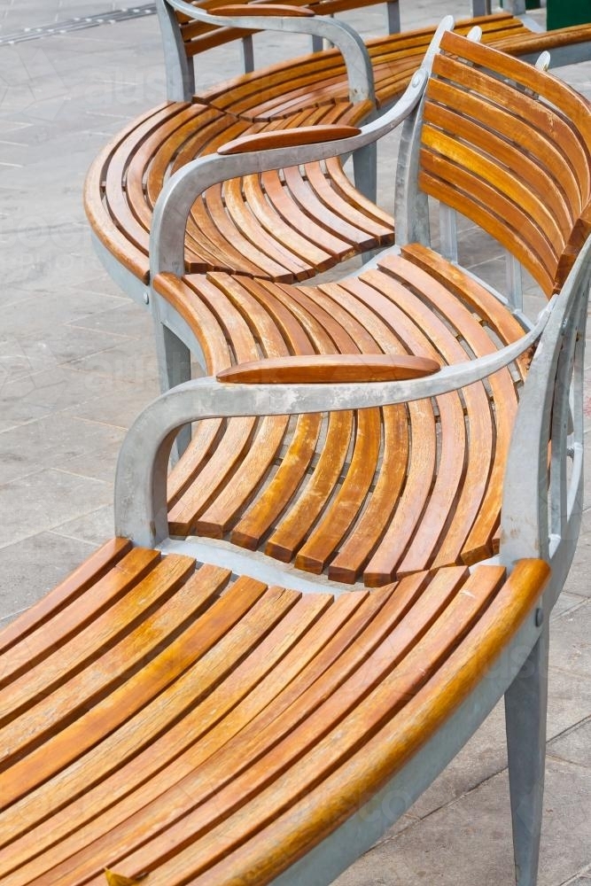 A curved wooden park bench in detail - Australian Stock Image