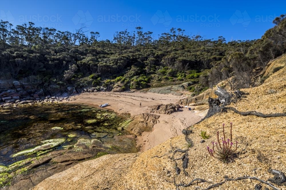 A dinghy on the sand of secluded Whalers Cove - Australian Stock Image