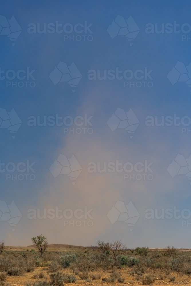 A dust devil blowing across an arid outback landscape - Australian Stock Image