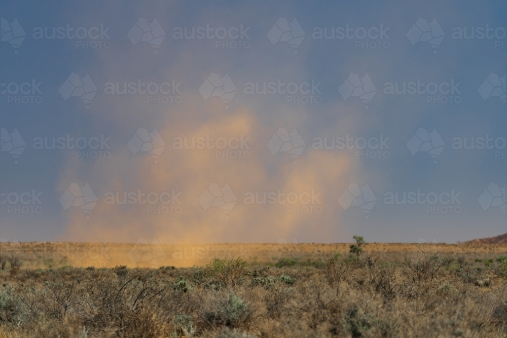 A dust devil sweeping across an arid outback landscape - Australian Stock Image