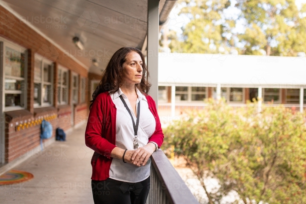 A Female Teacher Standing on a School Balcony - Australian Stock Image