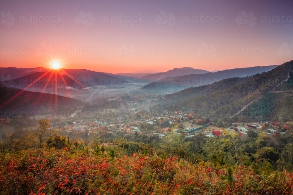 A foggy morning as the sun shines over the autumn town in rural Australia - Australian Stock Image