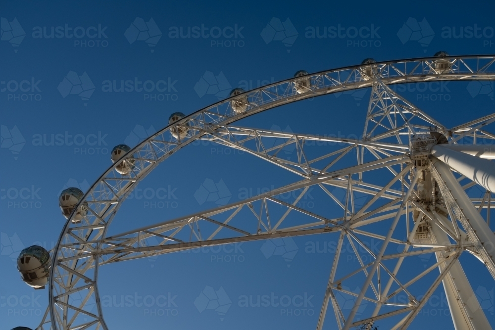 A generic large ferris wheel with gondolas to enjoy the view - Australian Stock Image