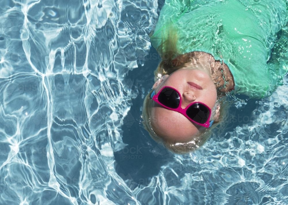 A Girl Floating in Water from above - Australian Stock Image