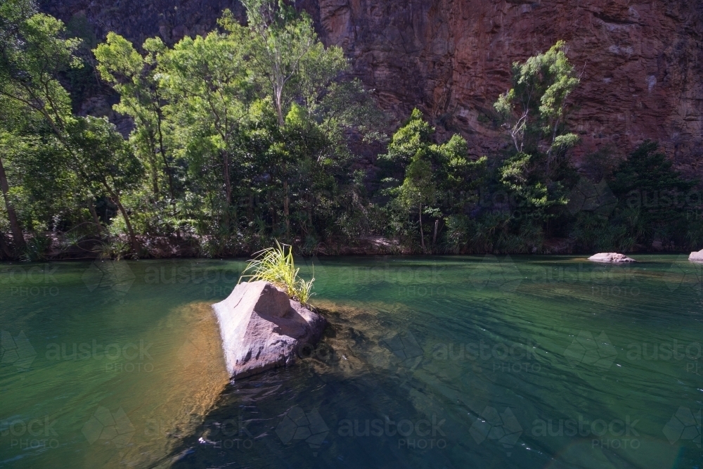 A large rock in the middle of the lake - Australian Stock Image